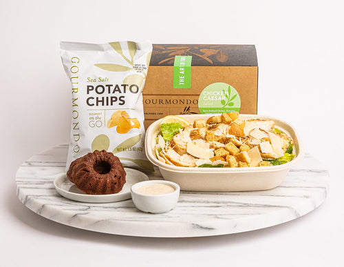 Boxed lunch with salad, potato chips, and bundt cake
