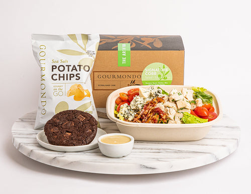 Boxed lunch with salad, potato chips, and bundt cake