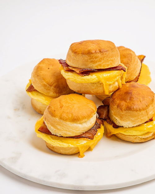 Platter of breakfast biscuit sandwiches with egg, cheese and bacon