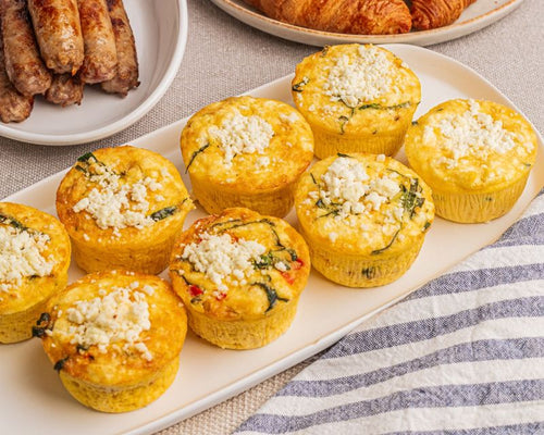 Platter of egg frittatas with vegetable mix-ins and goat cheese  topping