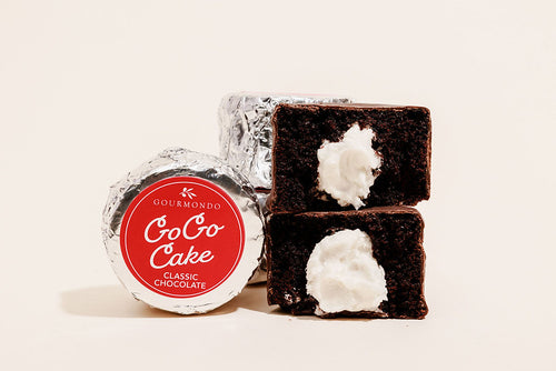 Mini chocolate covered cake with a cream filling stacked, both with foil and unwrapped 