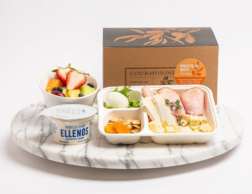 Breakfast box with deli meat, assorted cheeses, hardboiled egg, almonds, dried fruit, fruit cup, and yogurt