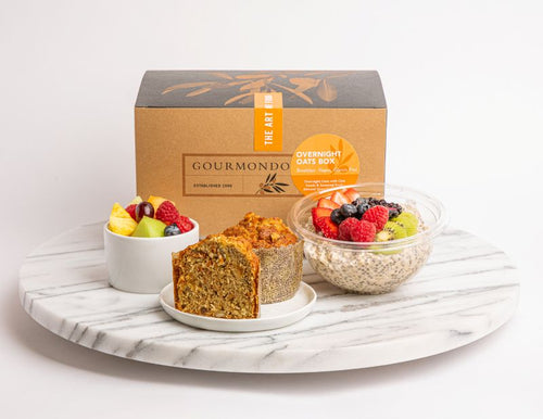 Breakfast box with muffin, overnight oats  bowl with fresh berries, and a fruit cup