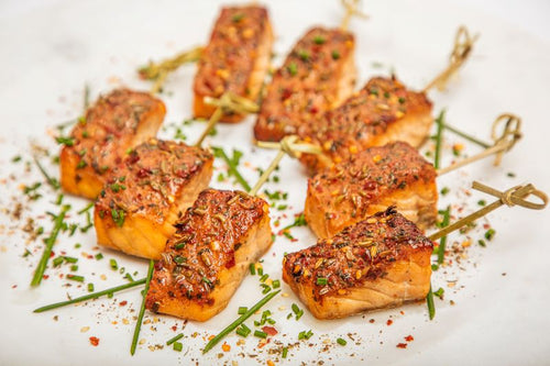 Skewers of salmon with a mesquite rub, topped with fresh herbs