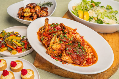 Package meal of tuscan chicken cacciatore, roasted potatoes, roasted vegetables, caesar salad, and lemon tarts