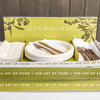 Branded cardboard box holding compostable plates, napkins, and cutlery