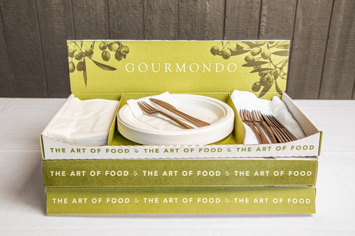 Branded cardboard box holding compostable plates, napkins, and cutlery