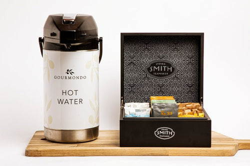 Pump pot of hot water with a box of assorted tea bags 
