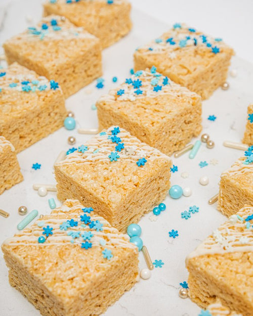 Classic rice krispie treats with light icing stripes and sprinkles topping