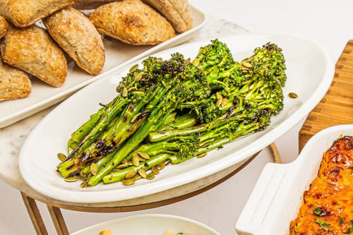 Platter of roasted broccolini topped with pepitas