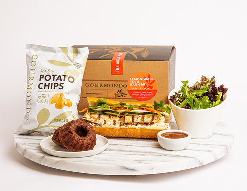 Box lunch with tofu banh mi sandwich, chips, side salad, and mini bundt