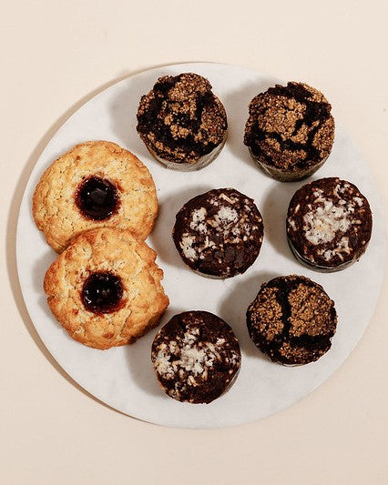 Chocolate muffins and scones with jam filling on a white board