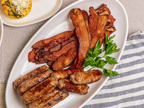 White platter with sausage links and bacon strips 