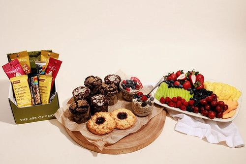 Breakfast package including breakfast pastries, overnight oats, assorted snacks, and fresh fruit