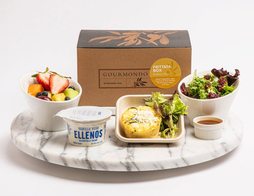 Breakfast box with baked egg frittata, mixed greens salad, yogurt, and fruit cup 