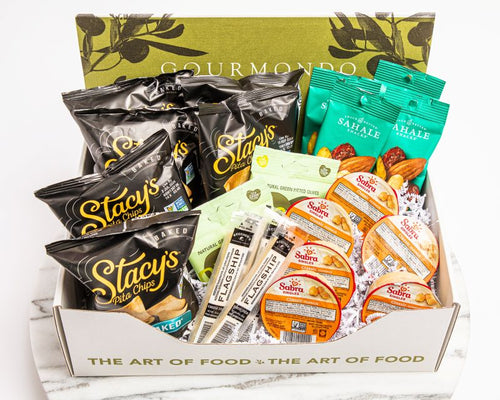Gourmondo branded box with snacks including pita chips, hummus cups, cheese sticks, and nuts
