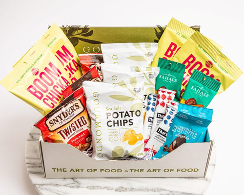 Gourmondo branded box filled with assorted chips, bars, and nuts