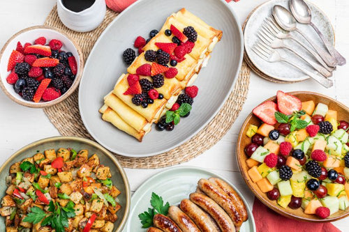 Breakfast package with cheese blintz, fresh fruit and berries, potato hash, and sausage links