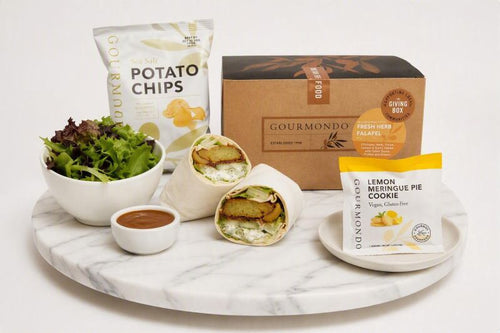 boxed lunch with falafel wrap, side salad, chips, and cookie