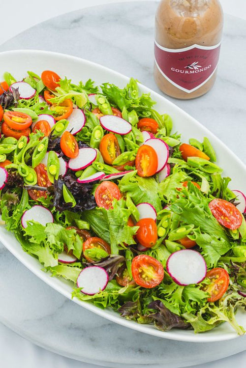 Seasonal mixed greens salad with fresh vegetables and house-made dressing from Gourmondo, perfect for catered lunches and events.
