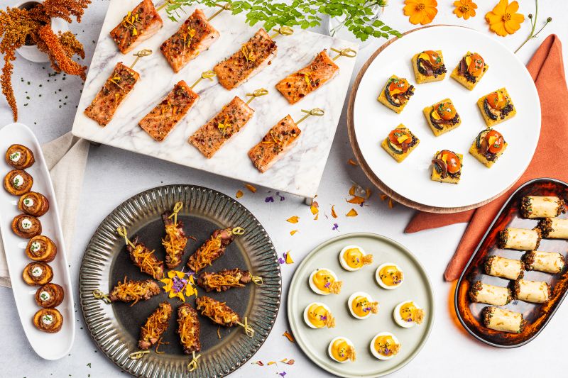 Premium cocktail reception catering featuring gourmet passed appetizers, including salmon skewers, deviled eggs, artisan crostini, savory pinwheels, and elegant canapés, perfect for weddings, corporate events, and private celebrations.