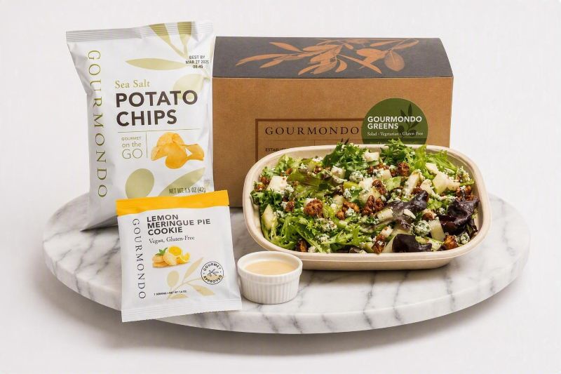 boxed lunch with gourmet greens salad, chips, and cookie 
