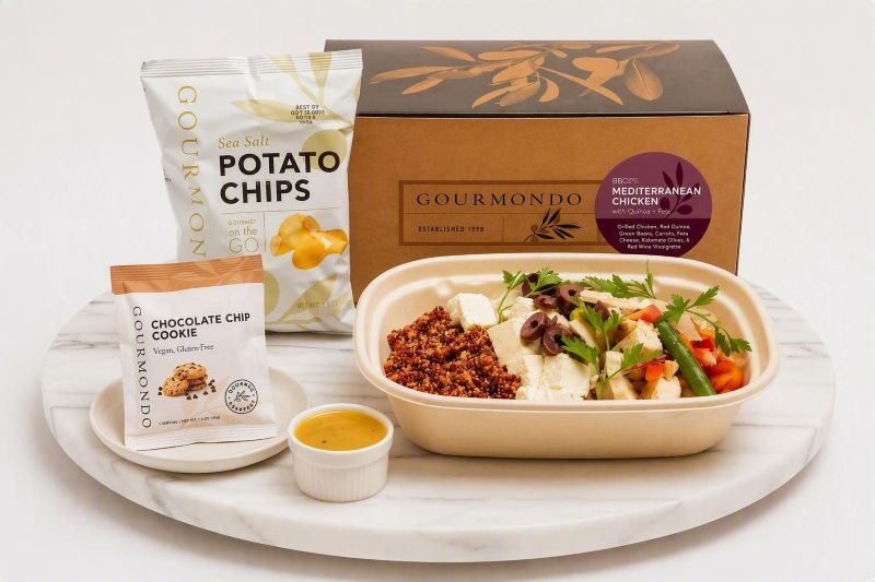 boxed lunch with  mediterranean chicken bowl, chips, and a cookie