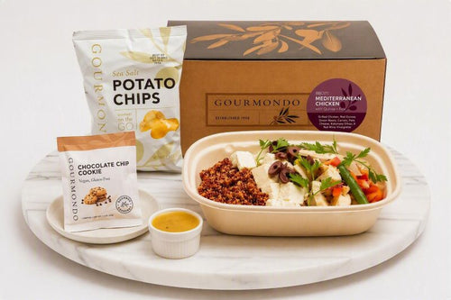 boxed lunch with  mediterranean chicken bowl, chips, and a cookie