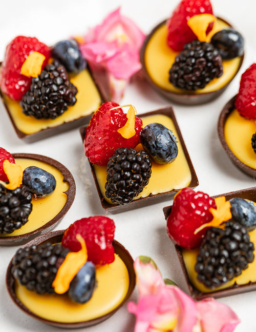 Chocolate cups with passionfruit ganache, topped with fresh berries