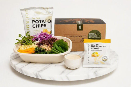 boxed lunch with vegetable salad, potato chips, and cookie 