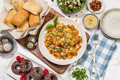 Rigatoni with hearty bolognese, in a lunch buffet with rolls, salad, and bundts 