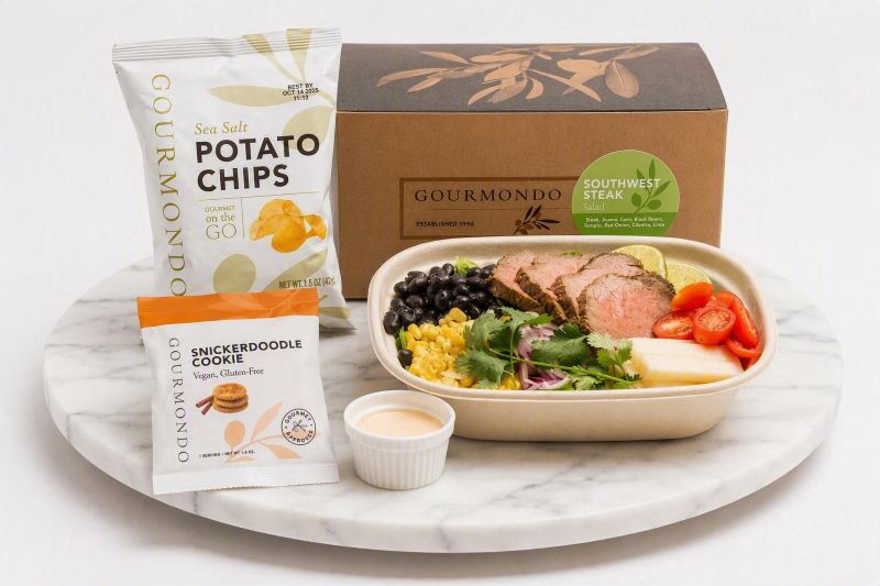 boxed lunch with steak salad, chips, and cookie 