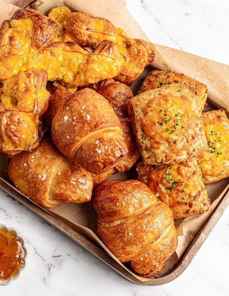Savory pastries including ham croissants, bacon pastry braids, and cheddar scones