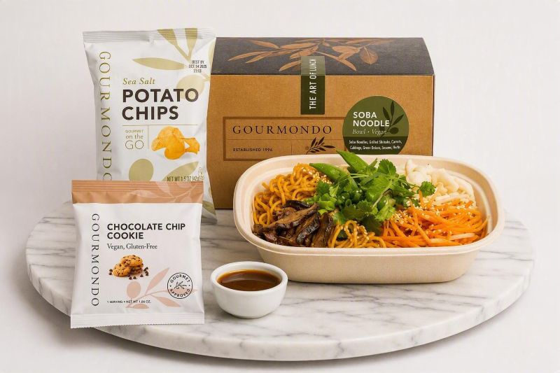 boxed lunch with soba noodle salad, potato chips, cookie 