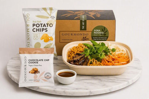 boxed lunch with soba noodle salad, potato chips, cookie 