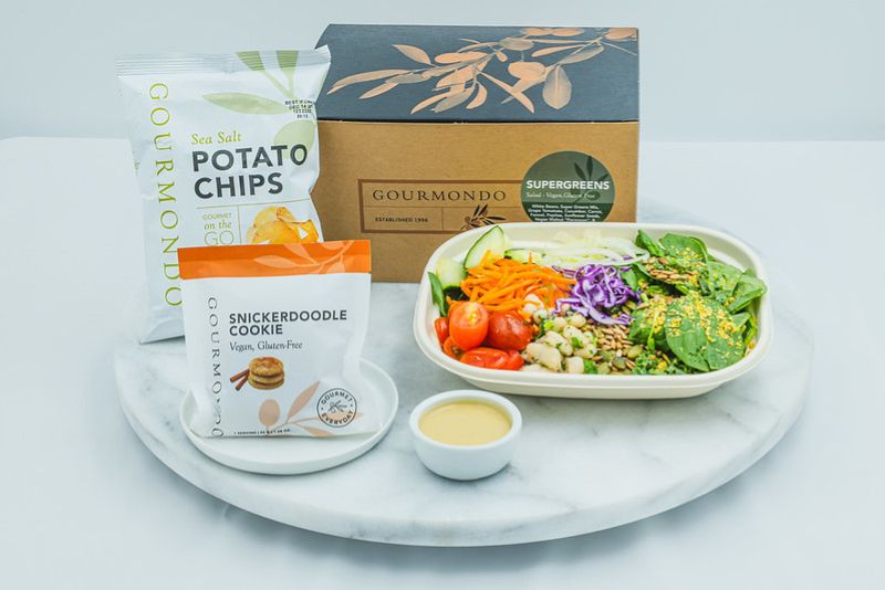 Healthy Supergreens boxed lunch from Gourmondo with mixed greens salad, fresh vegetables, house dressing, potato chips, and a gluten-free snickerdoodle cookie.