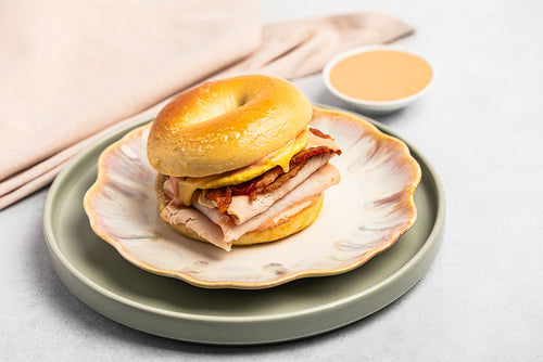 Bagel sandwich with turkey, egg, and bacon 