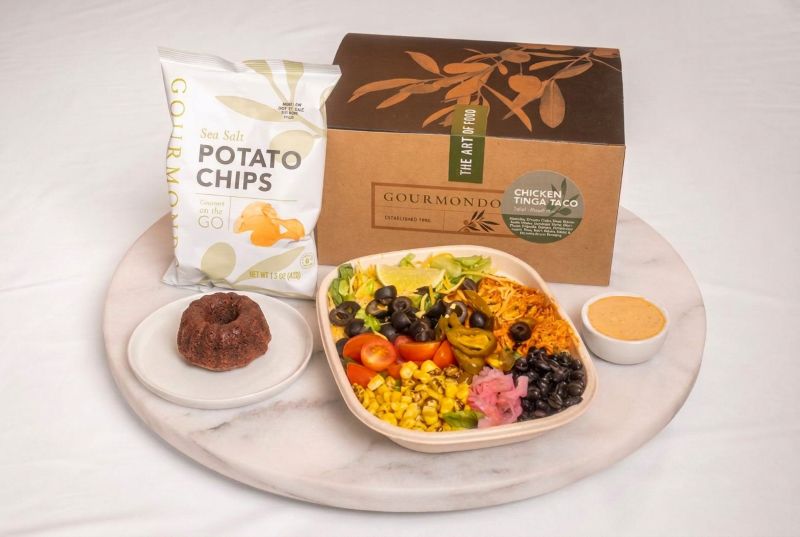 Boxed lunch with chicken taco salad, potato chips, mini bundt cake 