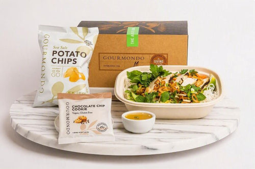 boxed lunch with tofu noodle bowl, chips and cookie 