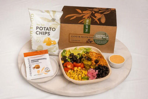 boxed lunch with chicken taco salad, chips, and cookie 